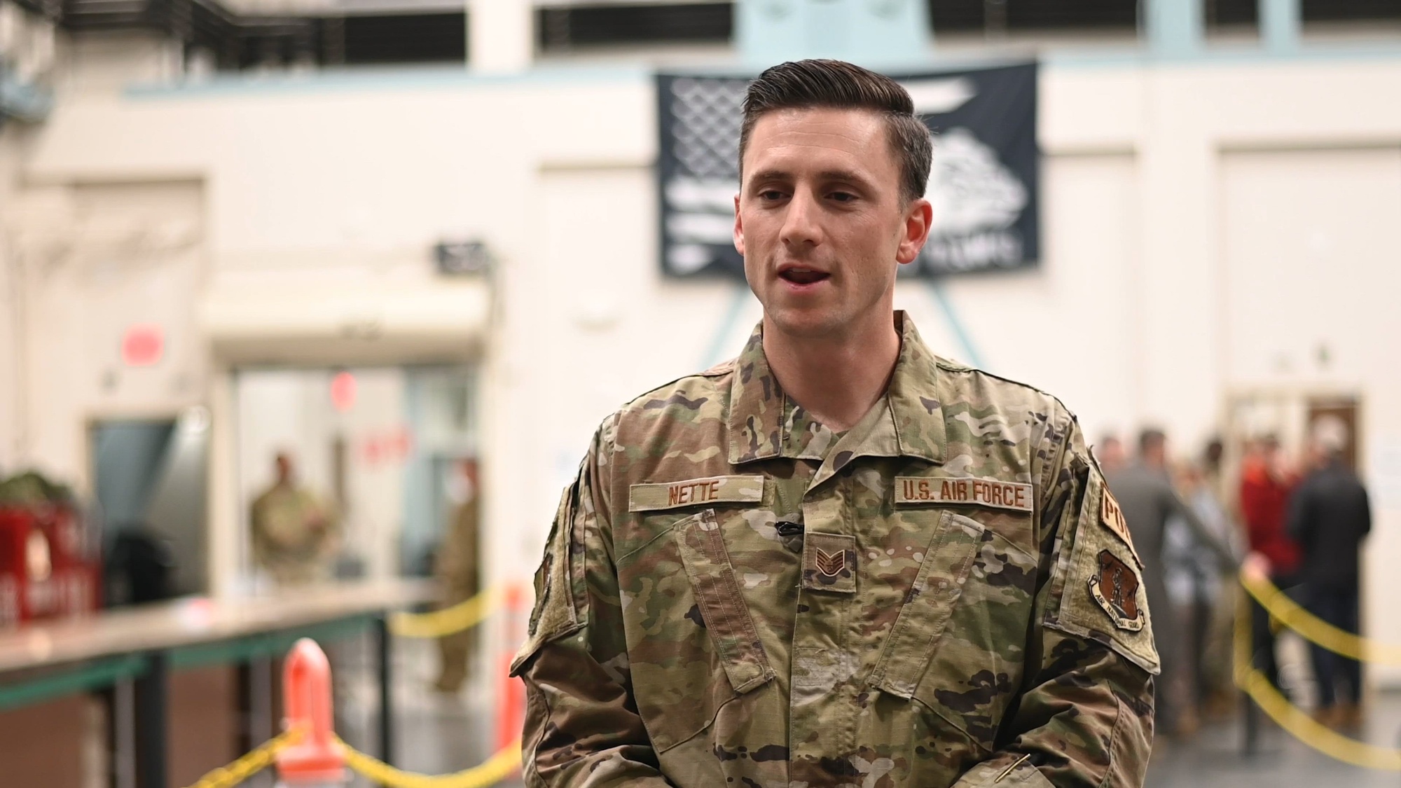 U.S. Air Force Staff Sgt. Coby Nette, aerial port technician, 129th Logistics Readiness Squadron, provides an overview of the deployment process at Moffett Air National Guard Base, Calif., Dec. 30, 2023. The processing line consisted of representatives from finance office, personnel, and medical to address any final concerns from the deploying Airmen. (U.S. Air National Guard video by Staff Sgt. Duane Ramos)