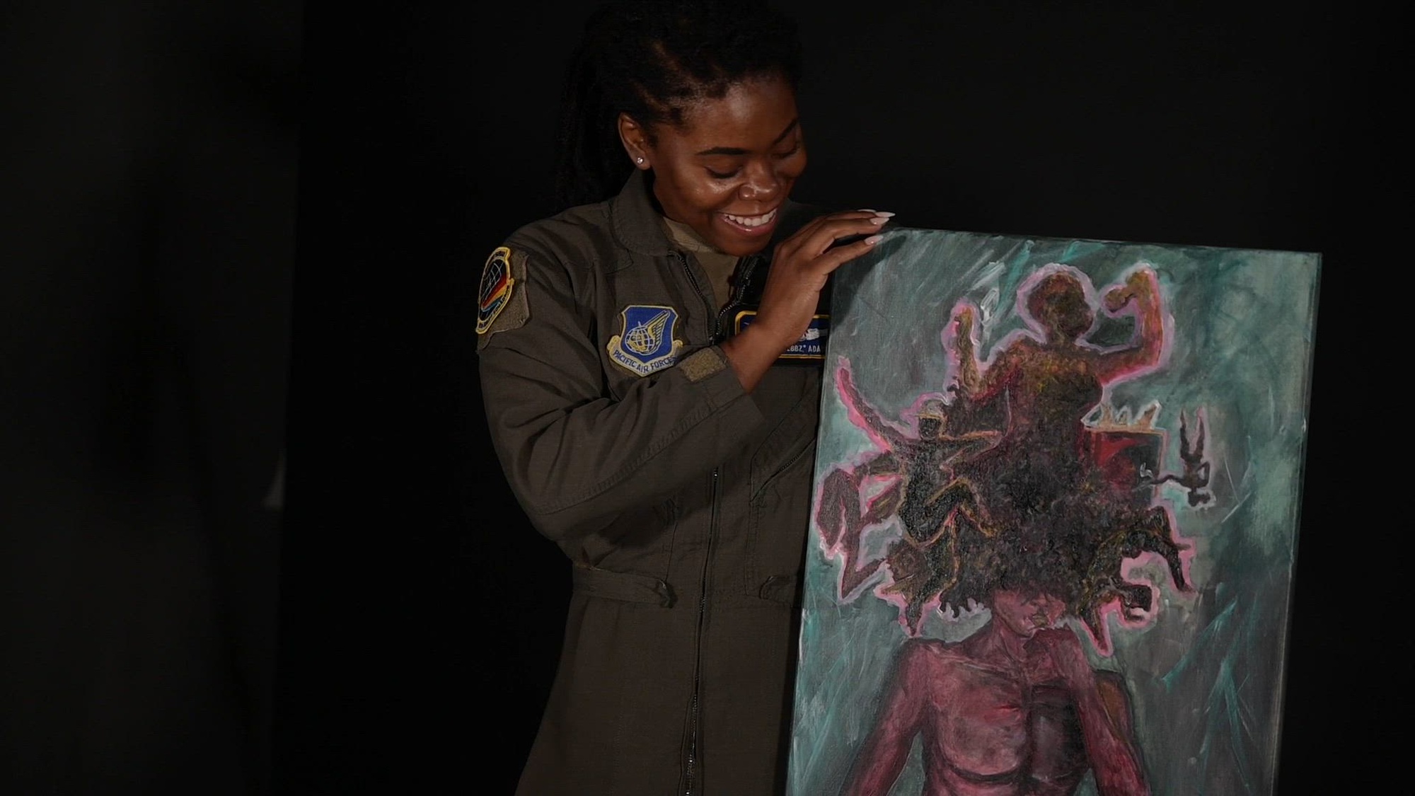 Staff Sgt. Ebony Adams, 65th Airlift Squadron flight attendant, shares her original painting entitled, hair and my creative juices, for Black History Month at Joint Base Pearl Harbor-Hickam, Hawaii, Jan. 18, 2024. Adams’ painting displayed a male sporting an afro with different art forms that have significance within the black community, which includes drawing, painting, music and dance. She also shared her love for earth tone colors and described the choice of color for the subject's skin to be an organ color, showcasing the essence and beauty of the black community. (U.S. Air Force video by Staff Sgt. Alan Ricker)