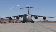 Marines with 3rd LAR load tactical vehicles onto Air Force C-17 Globemaster III cargo aircraft