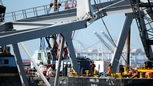 Crews use hydraulic shear to cut bridge truss