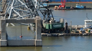 Salvors remove pieces of bridge wreckage