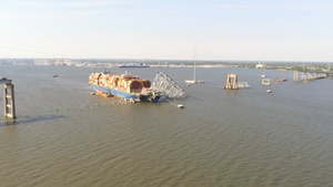 Drone footage of Key Bridge Unified Command removing portion of bridge on top of M/V Dali with precision charges