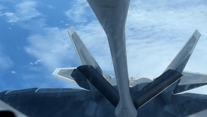 KC-135 Stratotanker refuels F-22 Raptors