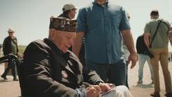 WWII Veteran, Ceo Bauer, rides a WWII Jeep on Utah Beach, Normandy, France