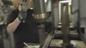 Iowa Army Ammunition Plant Employee moving M795 round case