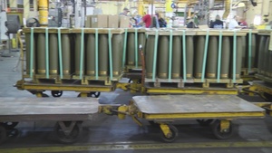 Pan left to right of M795 rounds on carts at Iowa Army Ammunition Plant