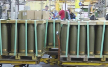 Pan left to right of M795 rounds on carts at Iowa Army Ammunition Plant