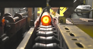 Heated and Shaped Billet Moving to Hot Inspect (Close-up)