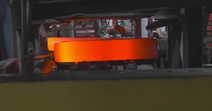 Conveyor Rotates and Distributes Heated/Shaped Billet Following Press Process