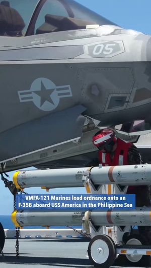 VMFA-121 load ordnance onto an F-35B aboard USS America