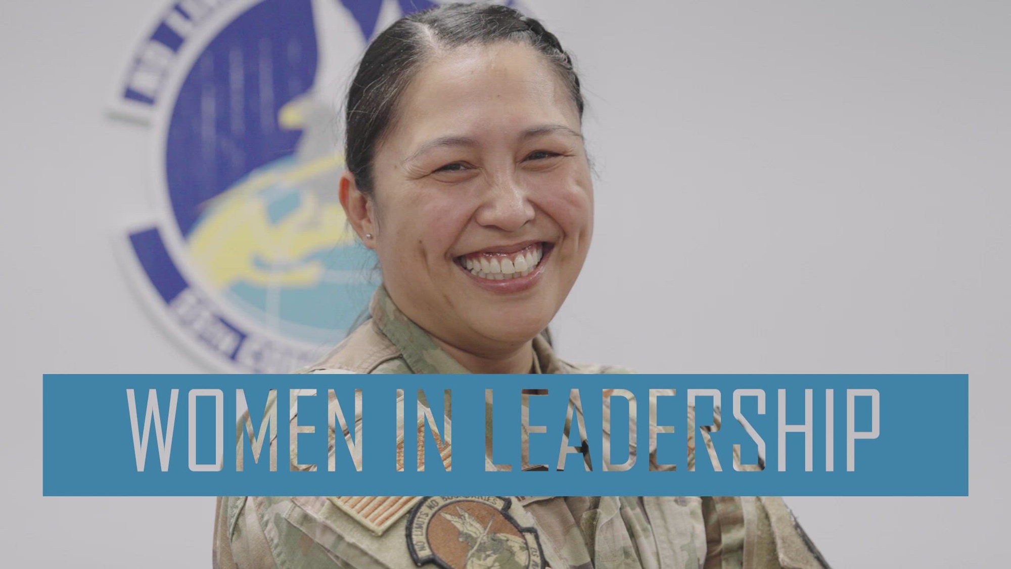 video thumbnail with woman in uniform smiling and words saying "WOMEN IN LEADERSHIP"