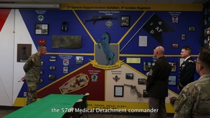 Battalions of 4th Combat Aviation Brigade present their mural displays in the Heritage Room to Maj. Gen. David Doyle and 4th Infinity Division