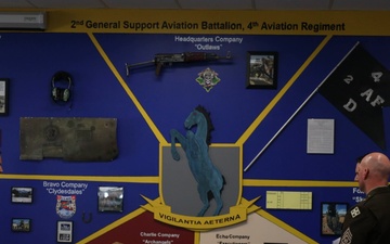 Battalions of 4th Combat Aviation Brigade present their mural displays in the Heritage Room to Maj. Gen. David Doyle and 4th Infinity Division