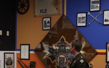 Battalions of 4th Combat Aviation Brigade present their mural displays in the Heritage Room to Maj. Gen. David Doyle and 4th Infinity Division