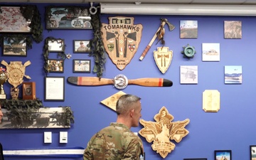 Battalions of 4th Combat Aviation Brigade present their mural displays in the Heritage Room to Maj. Gen. David Doyle and 4th Infinity Division