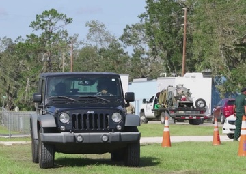 Florida Army National Guard's 53rd Brigade Support Battalion pass out water and food to civilians