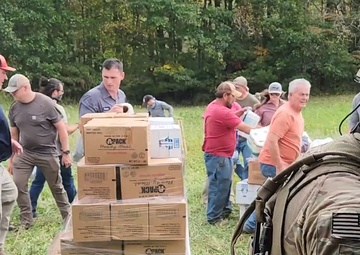 U.S. Army Soldiers prepare a CH-47 for deployment and distribution of food