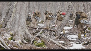 U.S. Marine Corps Mountain Warfare Instructors climb an ice wall with Argentine marines
