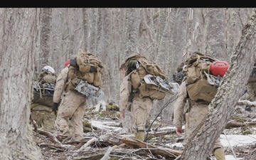 U.S. Marine Corps Mountain Warfare Instructors climb an ice wall with Argentine marines