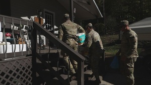 U.S. Army Soldiers assigned to the Joint Task Force - Civil Support, deliver supplies to a local communities.