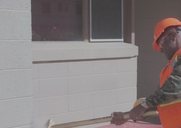 Brig. Gen. Brown Takes a Sledge Hammer to an Old Marine Barracks