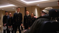 Navy midshipmen and U.S. Army soldiers visit with veterans at the Armed Forces Retirement Home