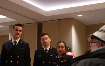 Navy midshipmen and U.S. Army soldiers visit with veterans at the Armed Forces Retirement Home