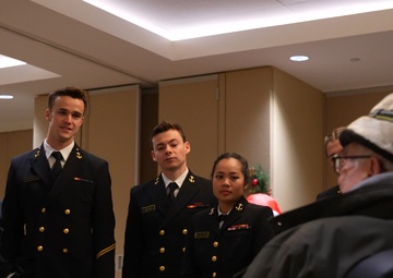 Navy midshipmen and U.S. Army soldiers visit with veterans at the Armed Forces Retirement Home