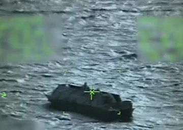 U.S. Coast Guard Air Station Traverse City crew hoist three Lake Michigan