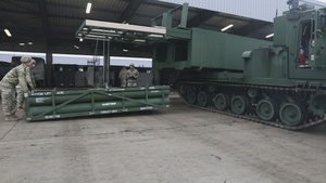 1-77 Field Artillery Regiment conducts maintenance on new Multiple Launch Rocket Systems