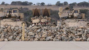 M2A3 Bradley Fighting Vehicle and Boeing AH-64 Apache Attack Helicopter engages targets during 3ABCT/1CD CALFEX ×