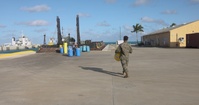 U.S. Marines with MWSS-272 load cargo onto a barge
