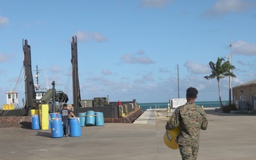 U.S. Marines with MWSS-272 load cargo onto a barge