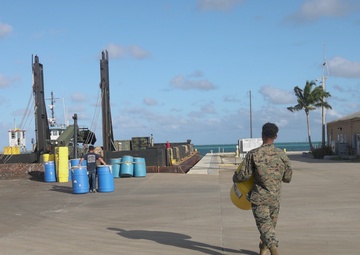 U.S. Marines with MWSS-272 load cargo onto a barge