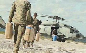 U.S. Marines with MWSS-272 load fuel onto a U.S. Navy MH-60R Seahawk