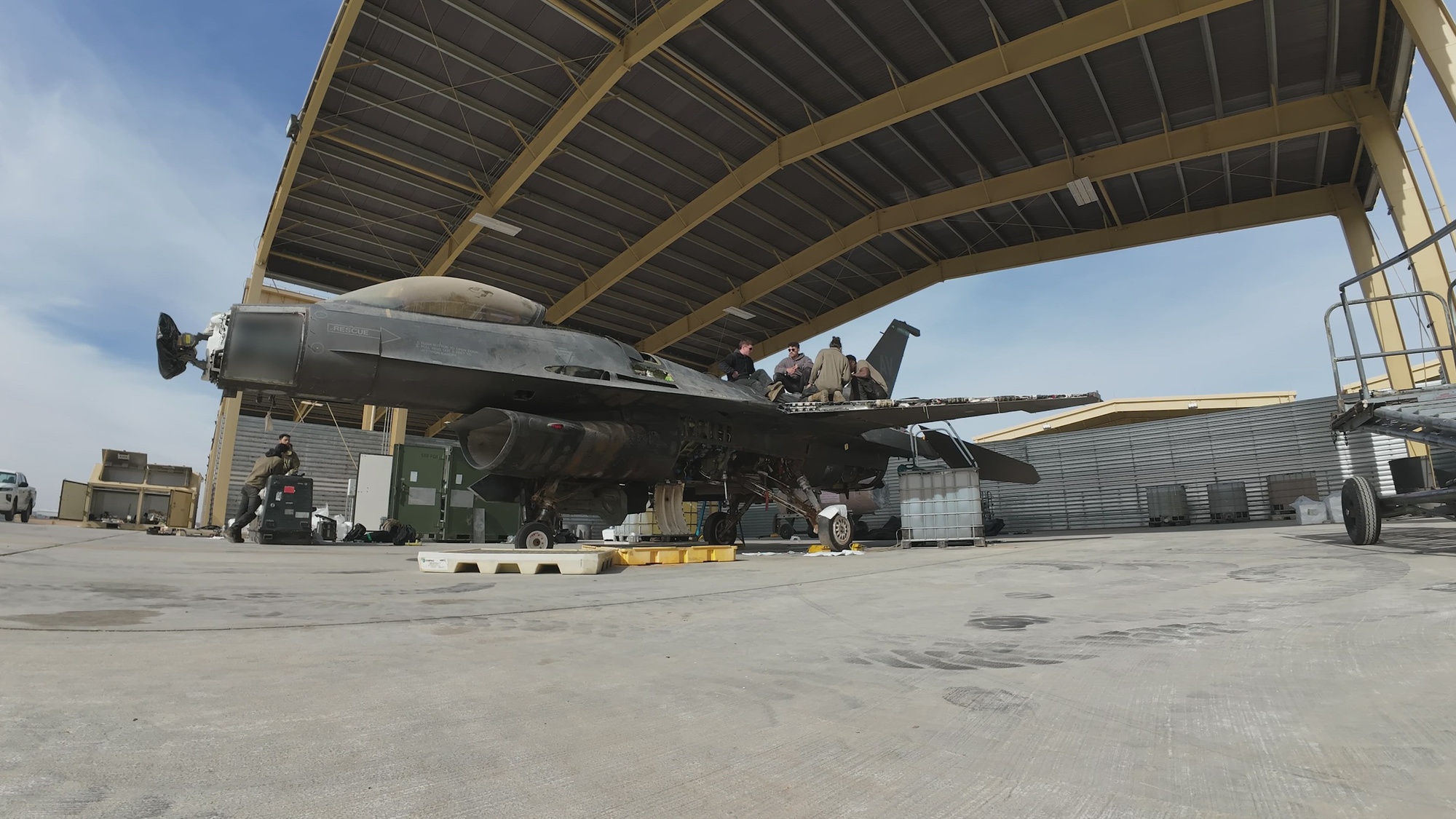 U.S. Airmen from Aviano Air Base, Italy, and Hill Air Force Base, Utah, salvage, pack and crate an F-16 Fighting Falcon, Dec. 6, 2024, in the U.S. Central Command area of responsibility. These two teams salvaged parts from the aircraft, saving the F-16 enterprise over $9.5 million dollars and removed the aircraft from the flightline, saving valuable space needed for working aircraft. (Portions of the video have been blurred for operational security purposes.) (U.S. Air Force video by Staff Sgt. Ricky Arnold)