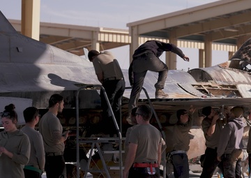 U.S. Airmen collaborate to pack and crate an F-16 Fighting Falcon for transport to the boneyard