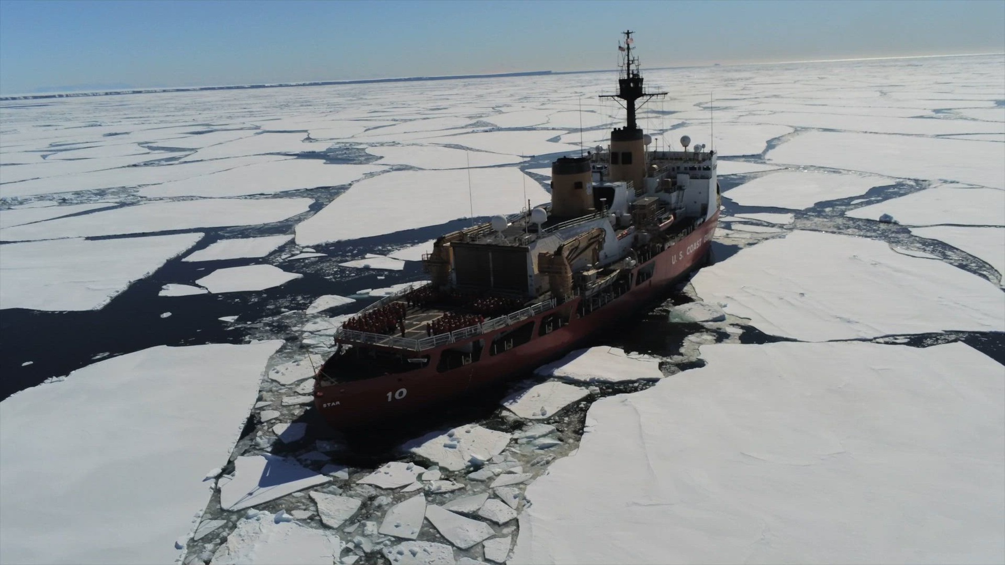 U.S. Coast Guard Cutter Polar Star (WAGB 10) crew gathers on the flight deck in recognition of the cutter&#39;s 49 years of service as the crew operates near Drygalski Ice Tongue in McMurdo Sound, Antarctica during Operation Deep Freeze, Jan. 17, 2025. Operation Deep Freeze is one of many operations in the Indo-Pacific in which the U.S. military promotes security and stability across the region.  (U.S. Coast Guard photo by Petty Officer 3rd  Class John Caleb Angkiangco)