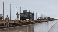 U.S. Soldiers offload and relocate approximately 50 M1126 Stryker armored vehicles