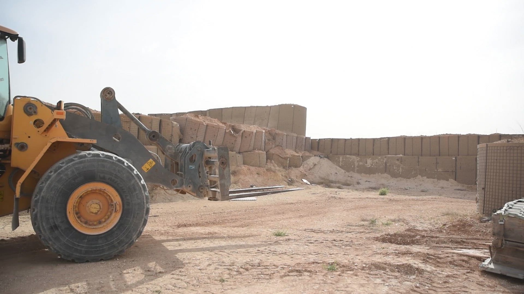 Coalition members load M2 Bradley Fighting Vehicle parts into a steel cargo shipping container in northeast Syria, April 7, 2025. The Coalition maintains readiness by having a ready supply of maintenance parts within the Combined Joint Operations Area to keep the Coalition’s BFVs in fully-mission-capable conditions. Coalition BFVs are just one of many assets that provide offensive and defensive capabilities to deter malign actors and support partner force efforts to maintain regional security and stability. (U.S. Army video by Master Sgt. Ray Boyington)