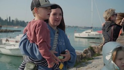 Families watch 173rd IBCT (A) paratroopers leap into Lake Garda during airborne water operation