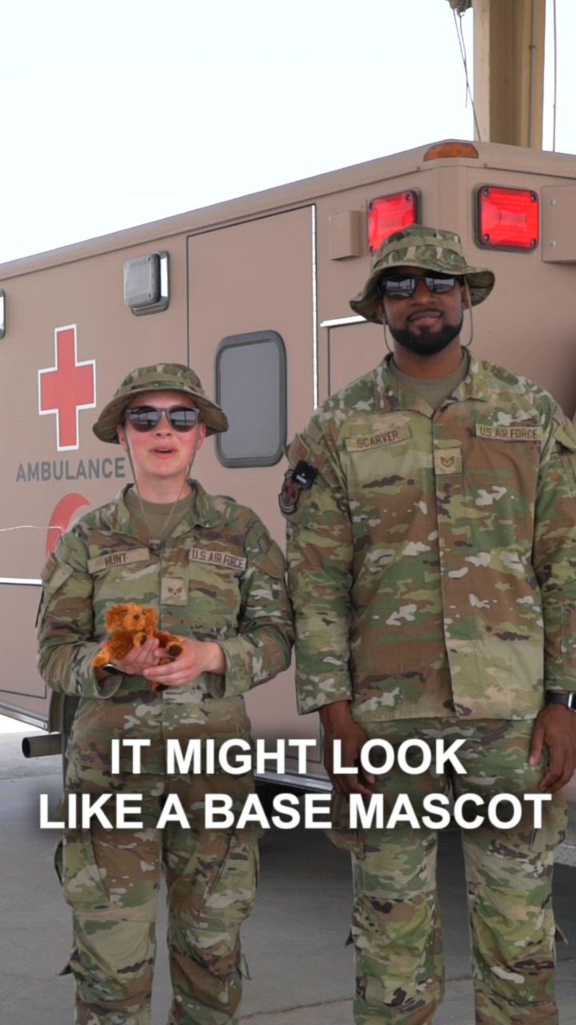 U.S. Air Force Tech. Sgt. Devante Scarver and Senior Airman Emily Hunt, both 386th Expeditionary Medical Squadron public health specialists, stand side-by-side and present a message regarding avoiding contact with animals, including pets, mascots or strays, during operations within the U.S. Central Command AOR.