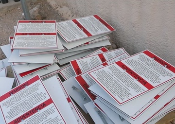 U.S. Soldiers place signs along the Texas National Defense Area