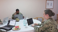 Participants of the Exercise Control Group Conduct a Simulated Scenario Exercise During Obangame Express 2025