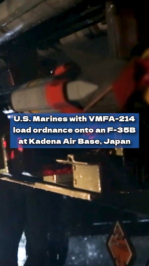 U.S. Marines load ordnance onto an F-35B Lightning II aircraft at Kadena Air Base, Japan