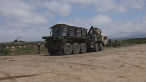 U.S. Marines with Task Force Sapper deliver concertina wire to the barrier
