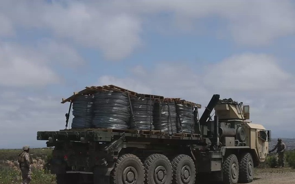 U.S. Marines with Task Force Sapper deliver concertina wire to the barrier