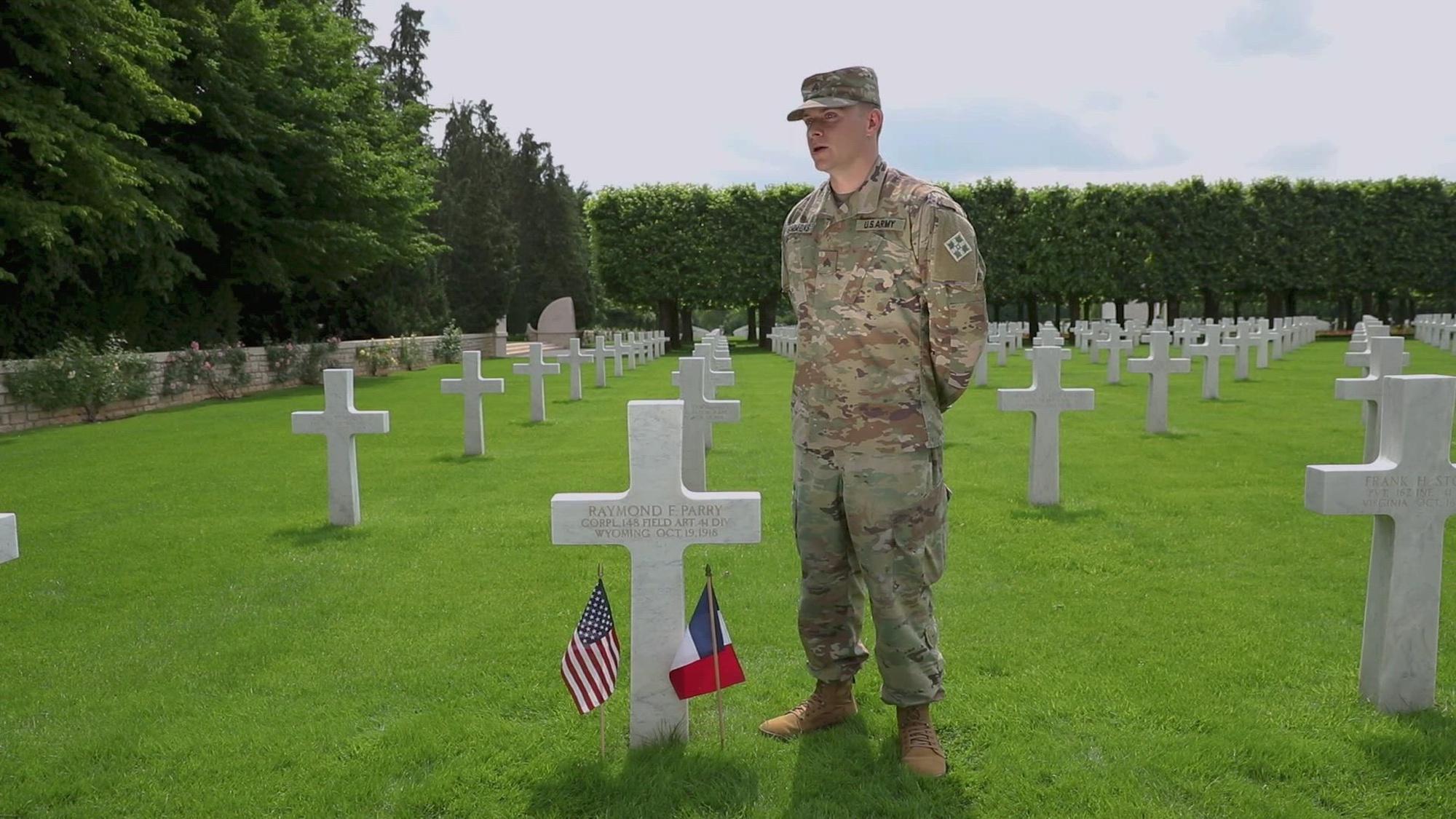 Sgt. John Simmons, a forward observer for Headquarters and Headquarters Battalion, 2nd Battalion, 77th Field Artillery Regiment, 4th Infantry Division Artillery, 4th Infantry Division, speaks on his family's legacy of service while participating in the 81st anniversary of D-Day June 2, 2025, at the St. Mihiel American Cemetary, Thiaucourt, France. His visit marks the first time since 1930 that a family member stood at Cpl. Raymond Parry's graveside.