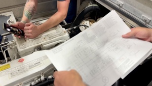 U.S. Coast Guard engineers troubleshoot small boat electronics