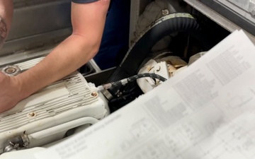 U.S. Coast Guard engineers troubleshoot small boat electronics